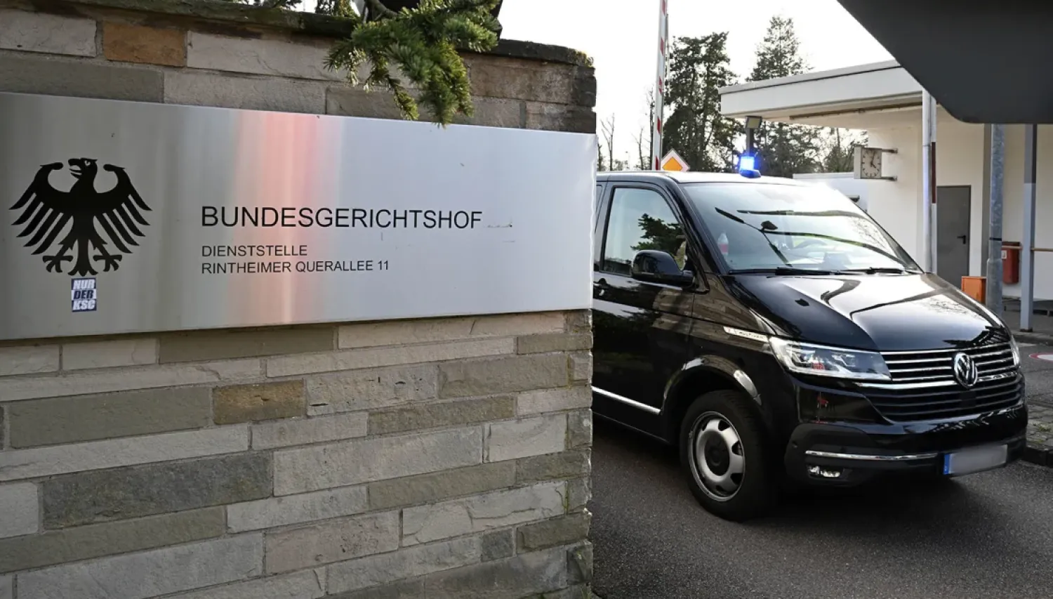 Police vehicles leave the Federal Public Prosecutor's Office at the Federal Court of Justice in Karlsruhe, Germany (AP)