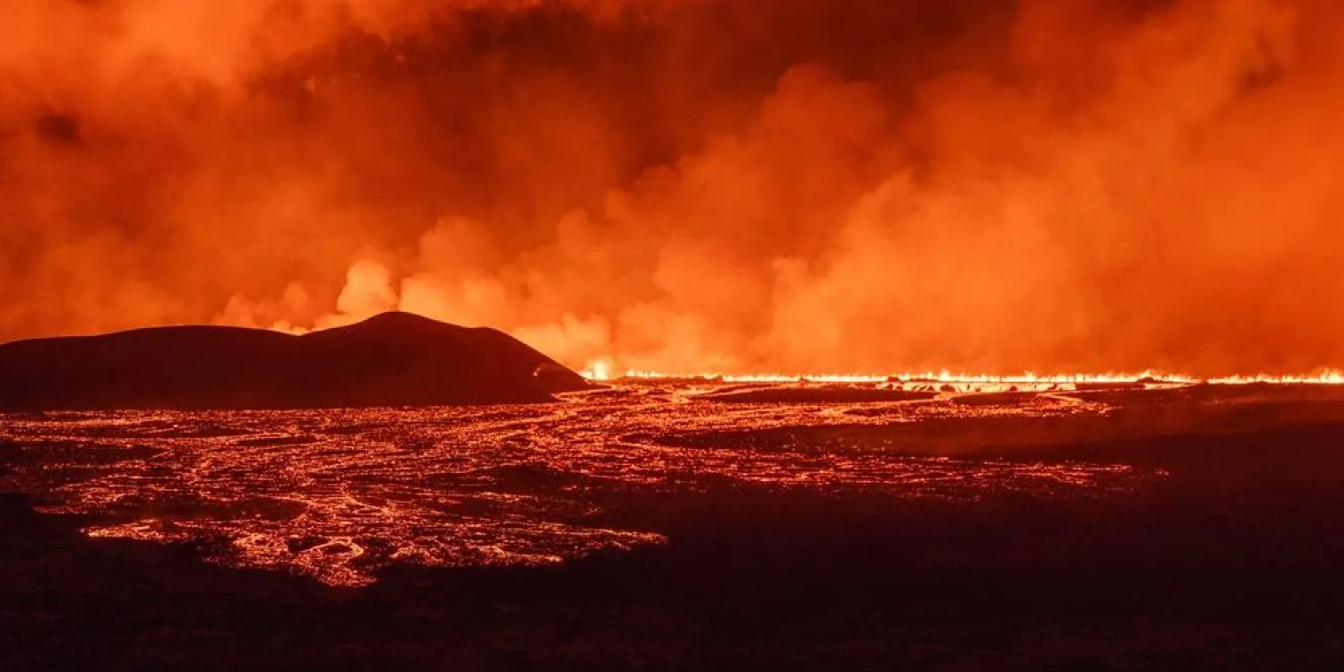 A photo taken during the night from August 22 to 23, 2024 shows lava and smoke erupting from a volcano near Grindavik on the Icelandic peninsula of Reykjanes. (AFP)