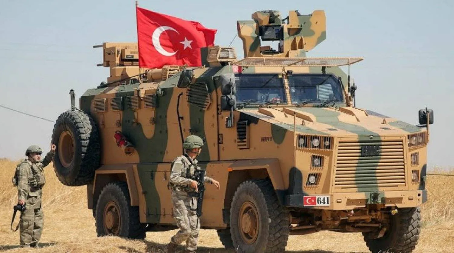 A Turkish soldier walks next to a Turkish military vehicle during a joint US-Türkiye patrol near Tel Abyad, Syria. (Reuters file)