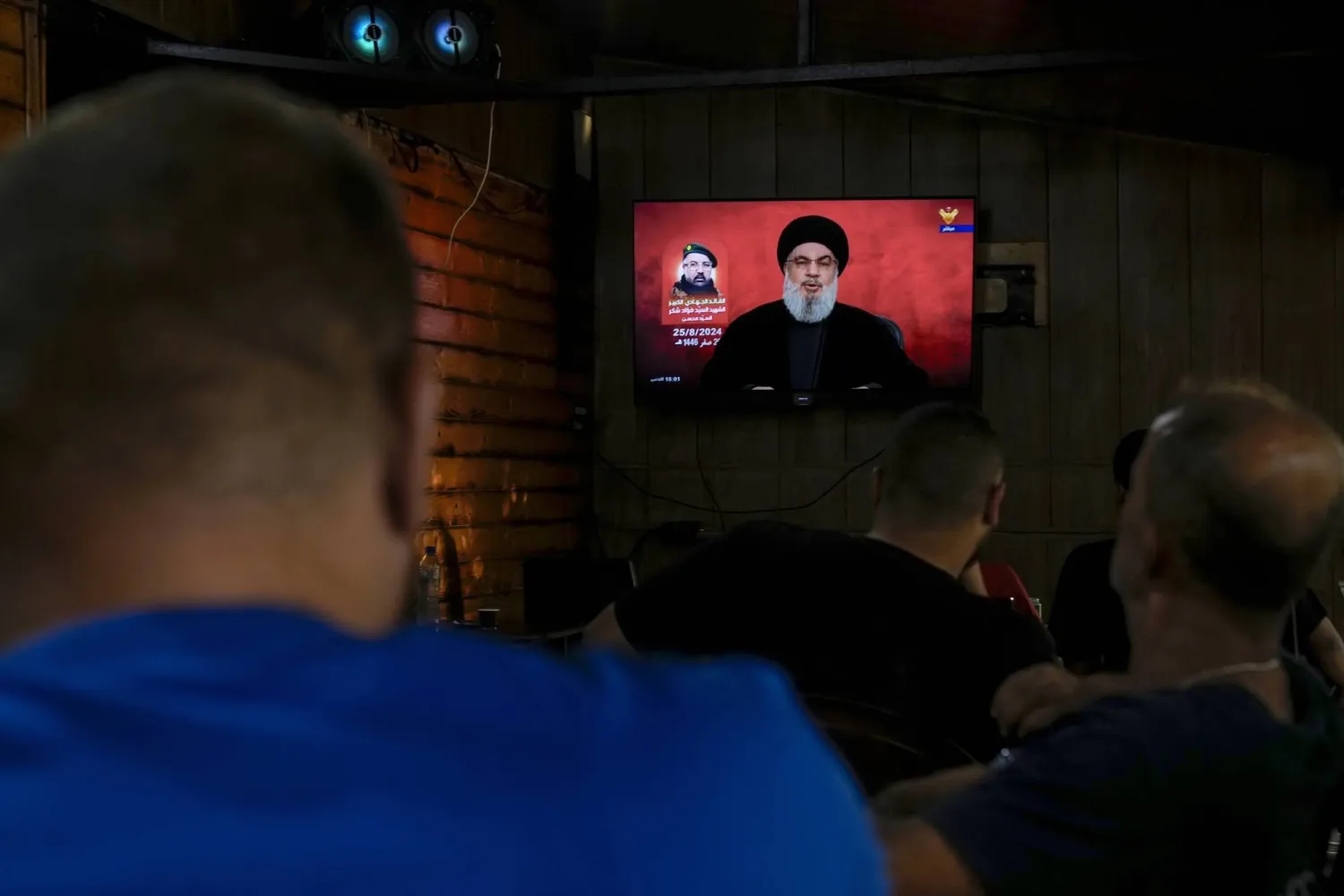 People listen to a speech by Hezbollah leader Hassan Nasrallah at a coffee shop in a southern suburb of Beirut, Lebanon, Sunday, Aug. 25, 2024. (AP Photo/Bilal Hussein)