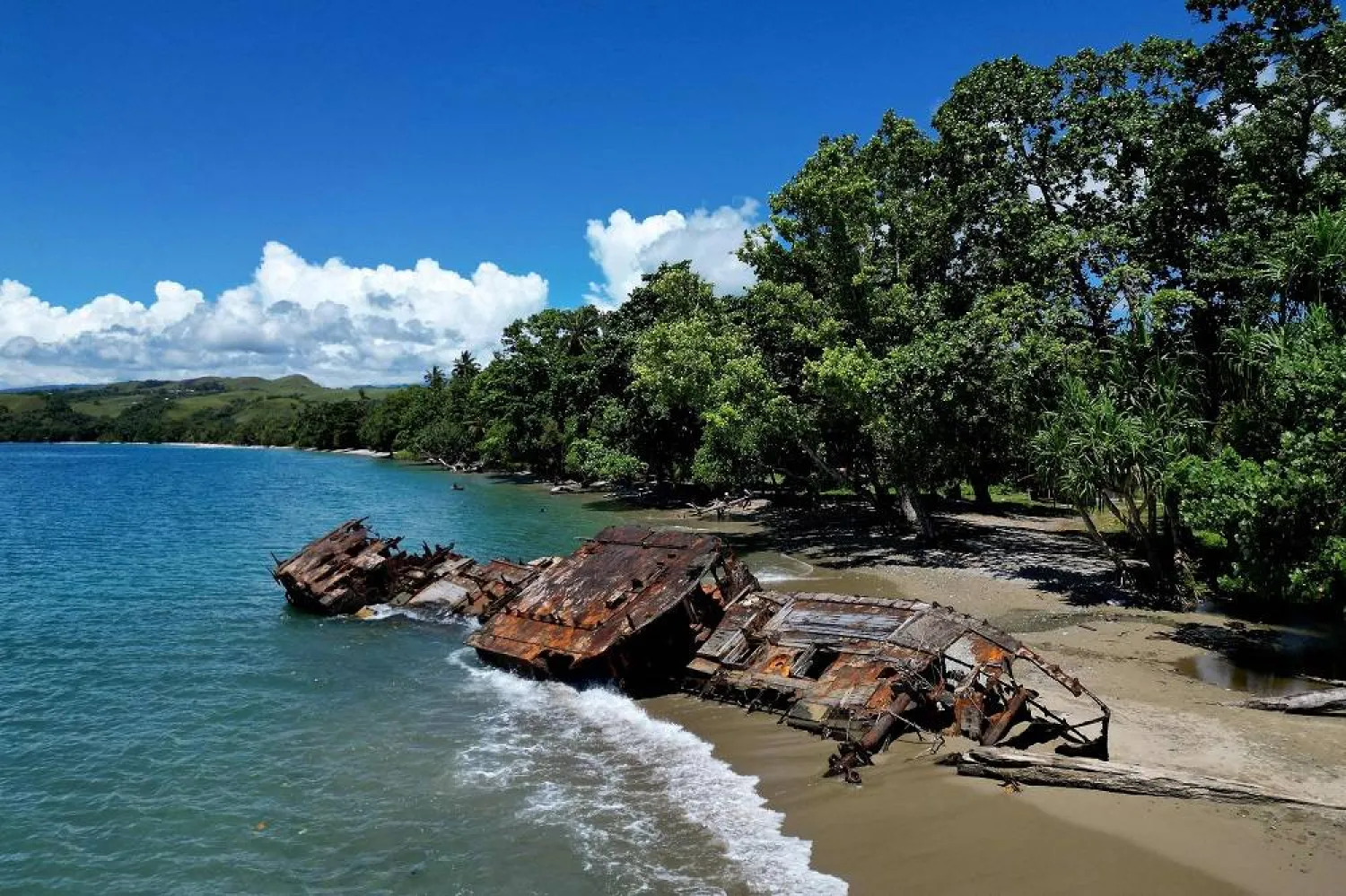 This picture taken on April 21, 2024 shows an aerial view of a washed up shipwreck on the shoreline on the outskirts of Honiara, capital city of the Solomon Islands. (AFP)