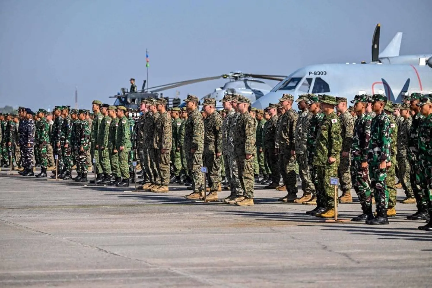 Military personnel from Indonesia, Japan, Singapore, Thailand, Britain and the US, among others, take part in the opening ceremony of the Super Garuda Shield joint military exercises, at the Indonesian Naval Aviation Center in Sidoarjo, East Java, Aug. 26, 2024. (AFP) 