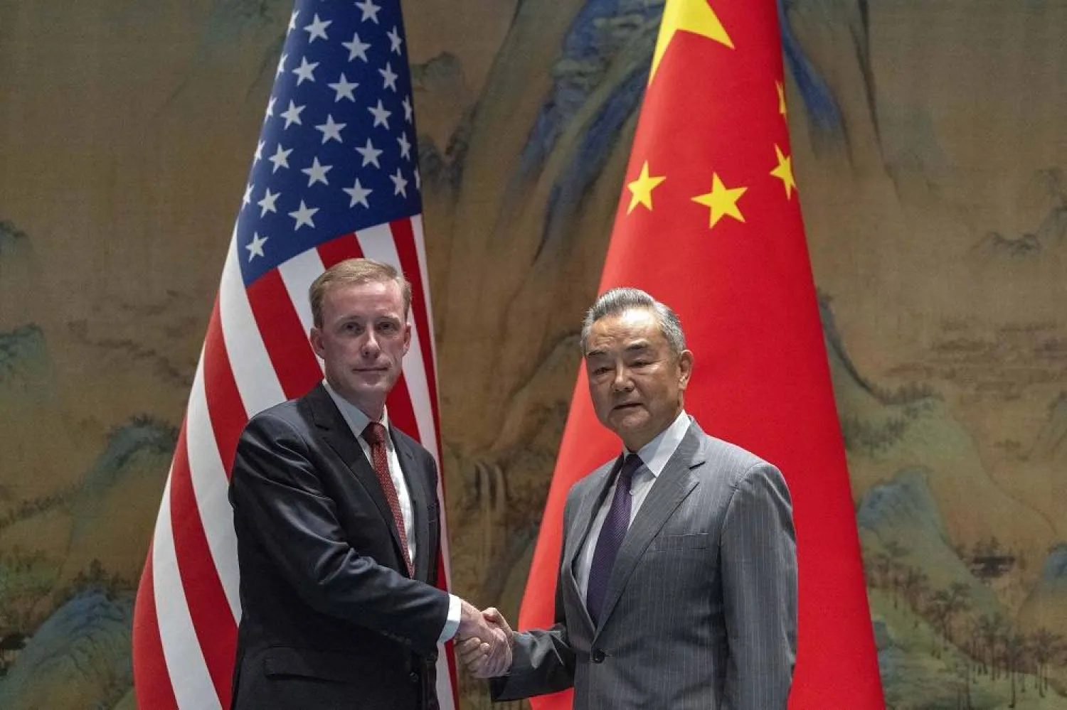 Wang Yi (R), Foreign Minister of China, shakes hands with US National Security Advisor Jake Sullivan at Yanqi lake in Beijing, China, 27 August 2024. (EPA)  