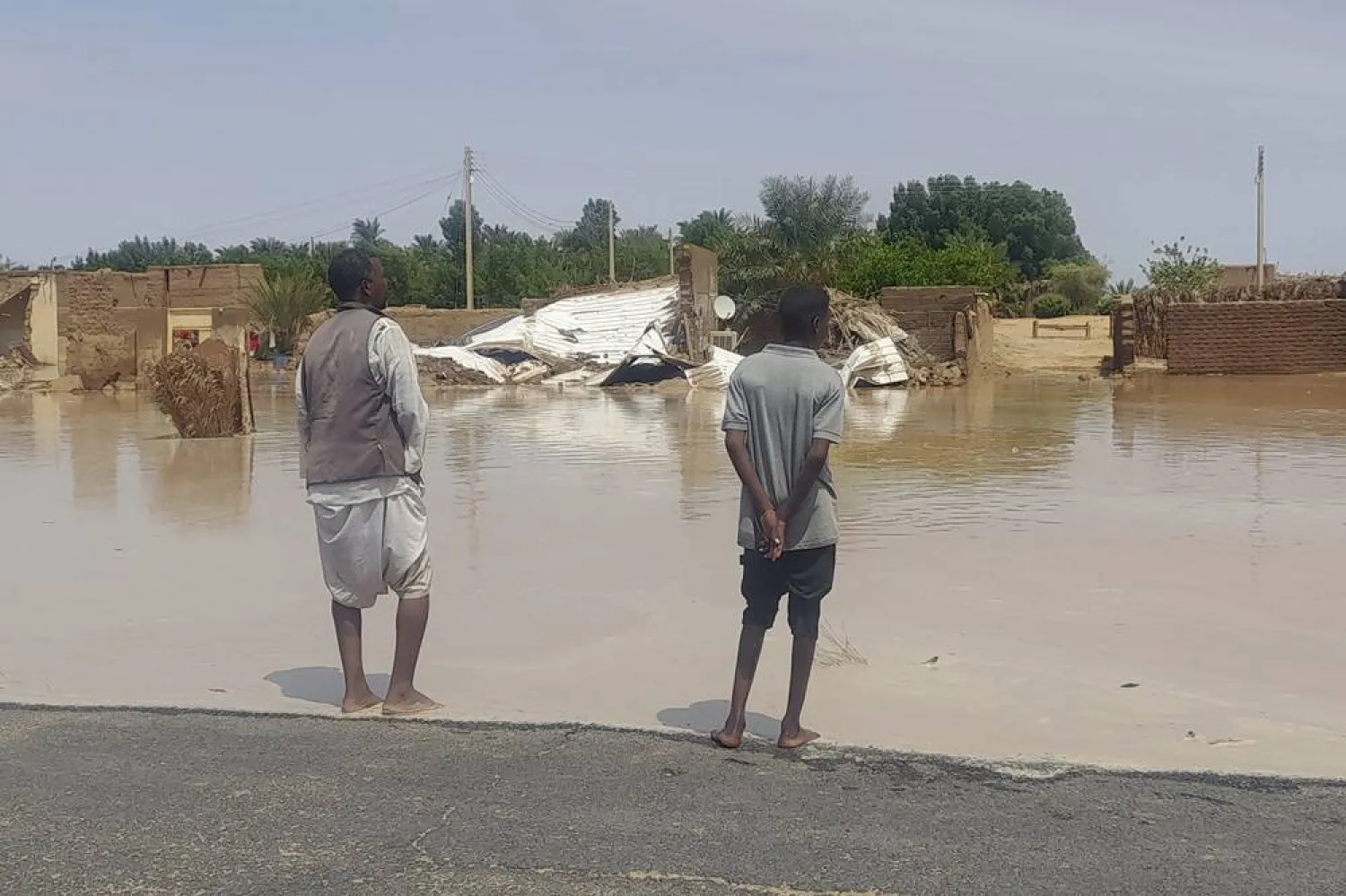  People look at their homes damaged by floods in Meroe, Sudan, Tuesday, Aug. 27, 2024. (AP) 