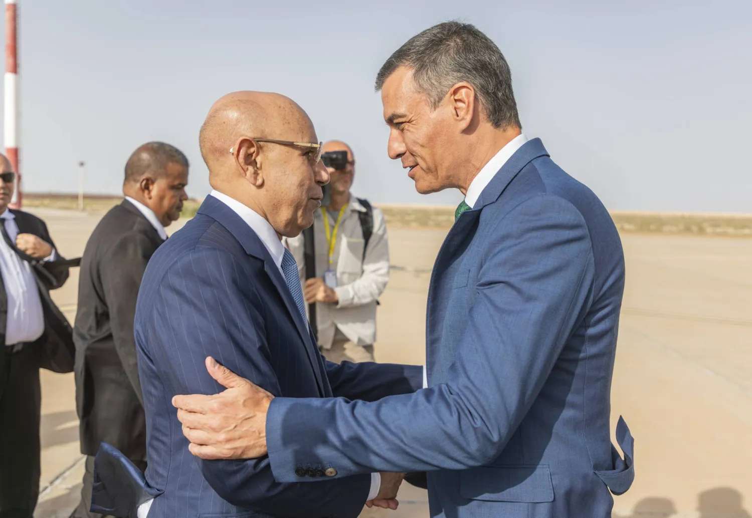 In this handout photo provided by the Mauritanian Presidency, Prime Minister of Spain Pedro Sánchez is welcomed by Mauritanian President Mohamed Ould Ghazouani, Tuesday, Aug. 27, 2024, in Nouakchott, Mauritania. (Mauritanian Presidency via AP)