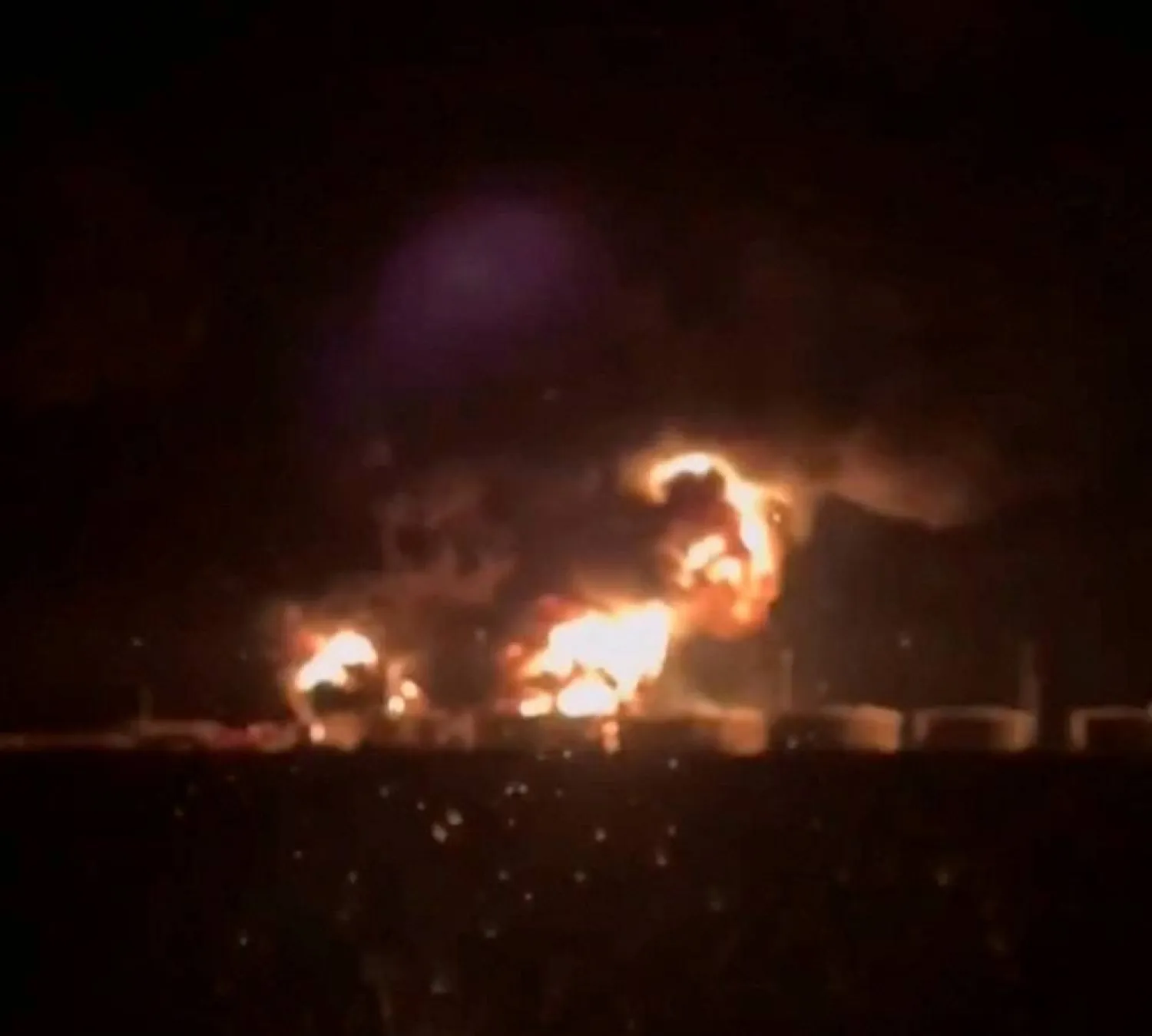 A view from a vehicle's glass window shows a fire in the oil tanks at the Glubokinskaya oil depot, in the course of Russia-Ukraine conflict, in Kamensky district, Rostov region, Russia in this screen grab from social media video released August 28, 2024. (Video obtained by Reuters/via Reuters) 