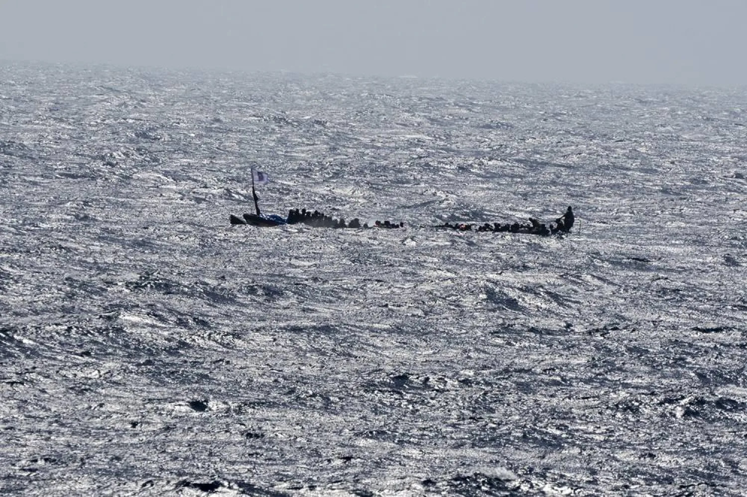 Migrants crowd a wooden boat as they sail to the port in La Restinga on the Canary island of El Hierro, Spain, Sunday, Aug. 18, 2024. (AP)