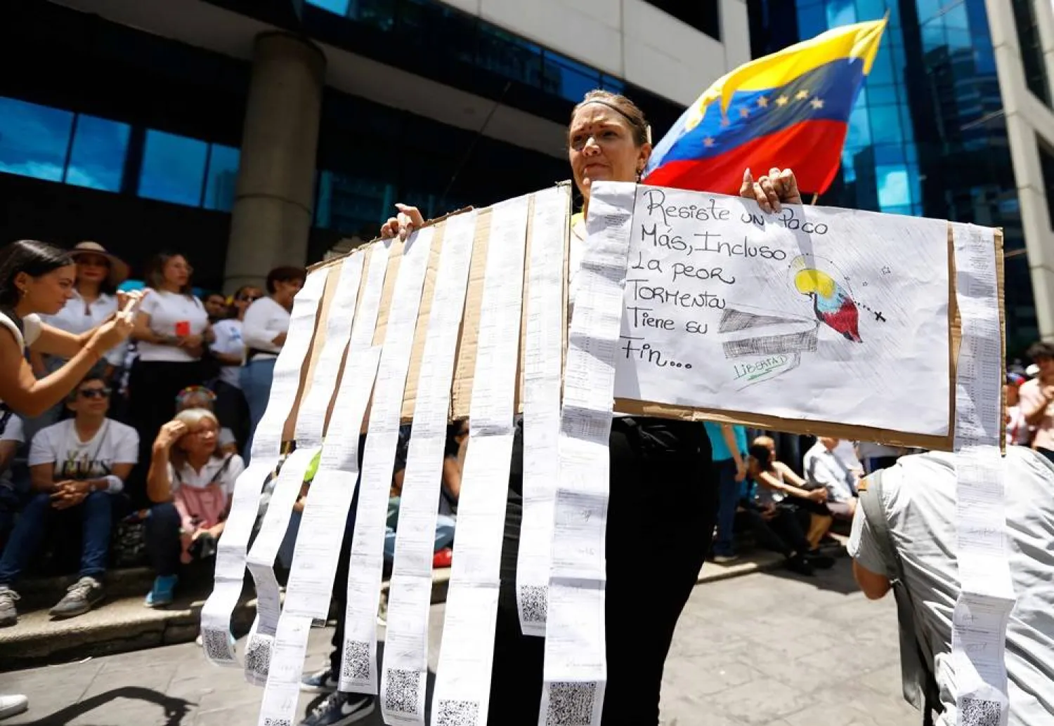 A woman holds electoral records on a board during a rally called by the opposition in Caracas on August 28, 2024. (AFP)