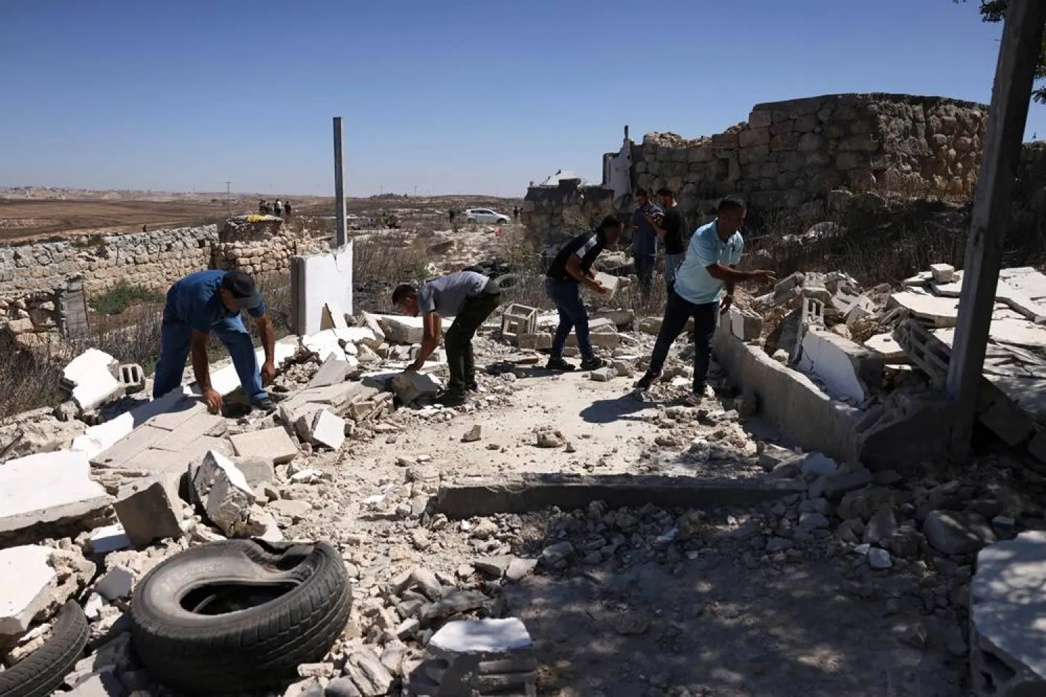 Palestinians inspect the damage in Zanuta village, south of Yatta in the area of Hebron in the Israeli-occupied West Bank, on August 21, 2024, upon their return to the village after they were forced out by Israeli settlers. (AFP)