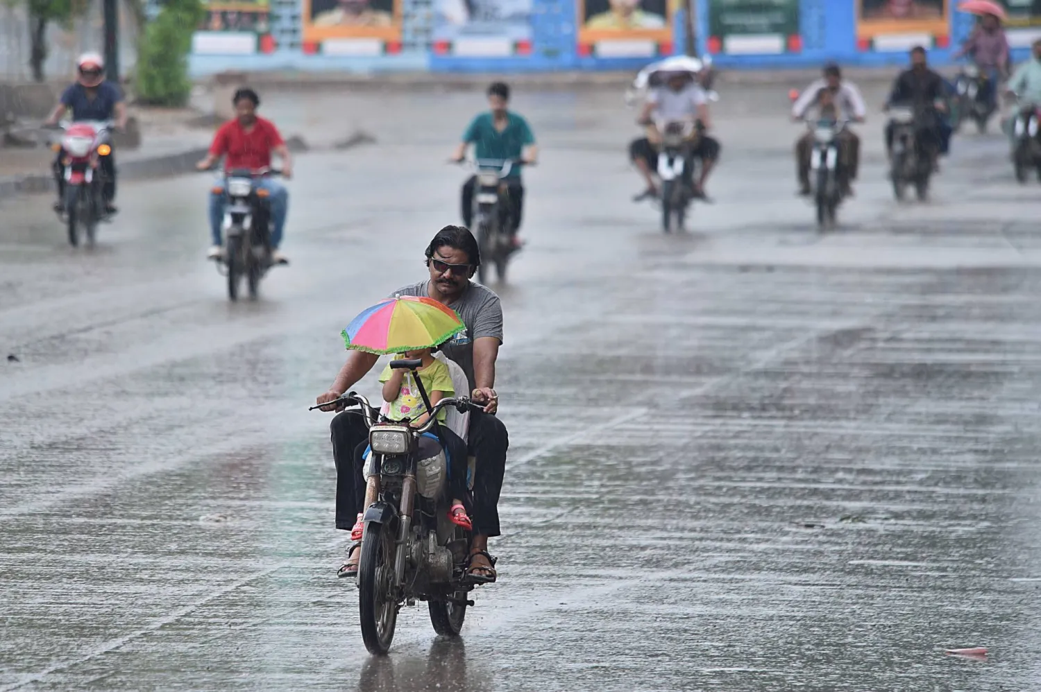 People make their way on motorbikes during heavy downpour in Karachi, Pakistan, 28 August 2024. EPA/SHAHZAIB AKBER