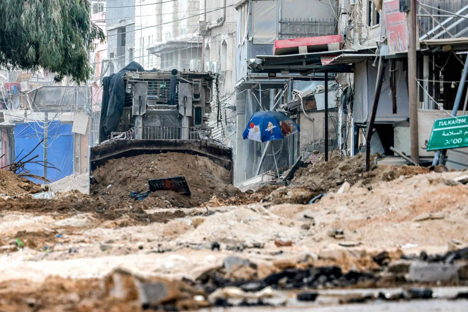 Israeli army excavators dig up a road during a military operation in Tulkarm in the north of the occupied West Bank on August 29, 2024. (Photo by Jaafar ASHTIYEH / AFP)