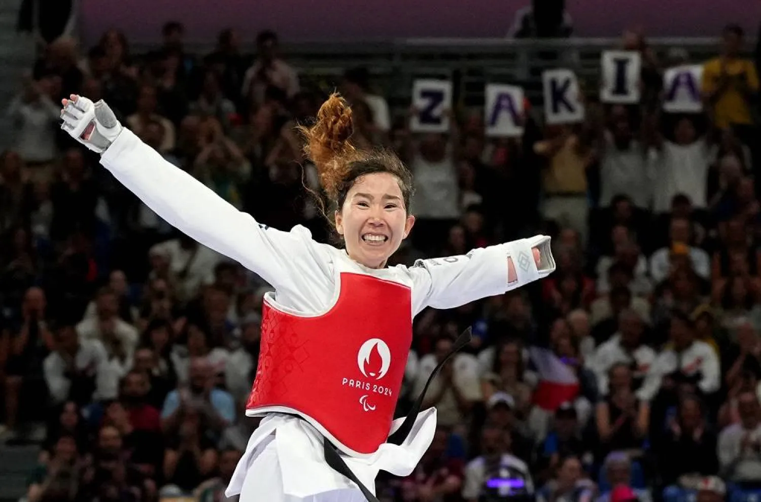 Paris 2024 Paralympics - Taekwondo - Women K44 -47kg Repechage - Grand Palais, Paris, France - August 29, 2024 Zakia Khudadadi of Refugee Paralympic Team celebrates winning her fight against Nurcihan Ekinci of Türkiye. (Reuters)