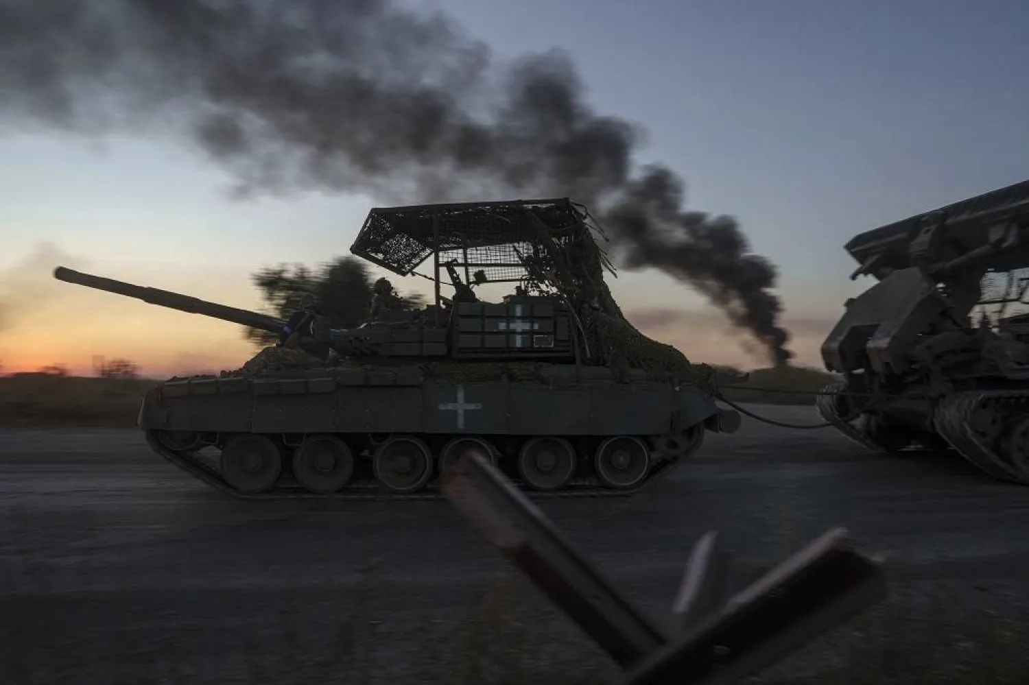 Ukrainian servicemen ride atop a tank after returning from Russia, near the Russian-Ukrainian border in the Sumy region, Aug. 17, 2024. (AP)