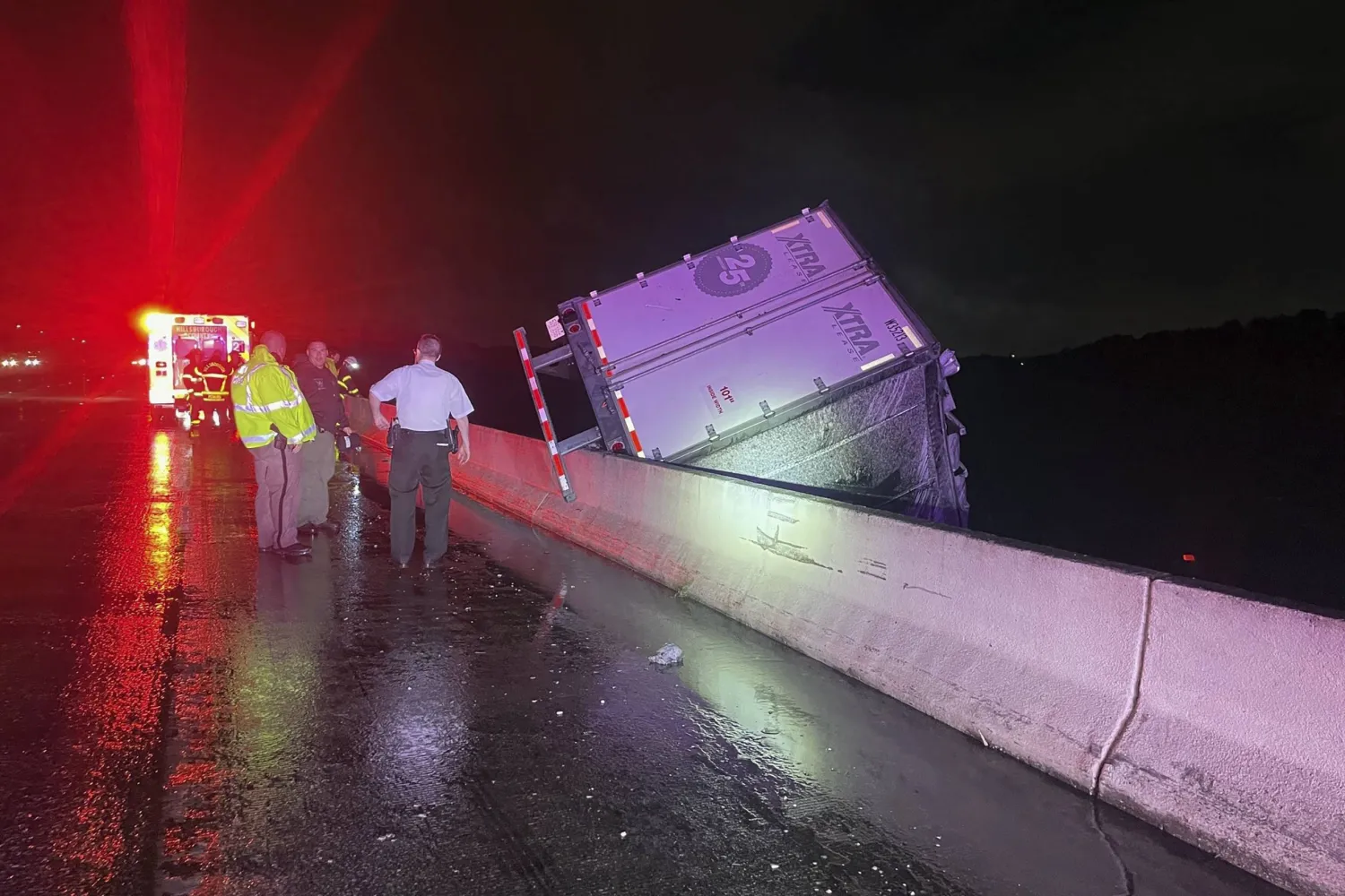 A tractor trailer dangles from a bridge on Interstate 75 near Tampa, Fla., early Monday, Aug. 5, 2024. (Florida Highway Patrol via AP)