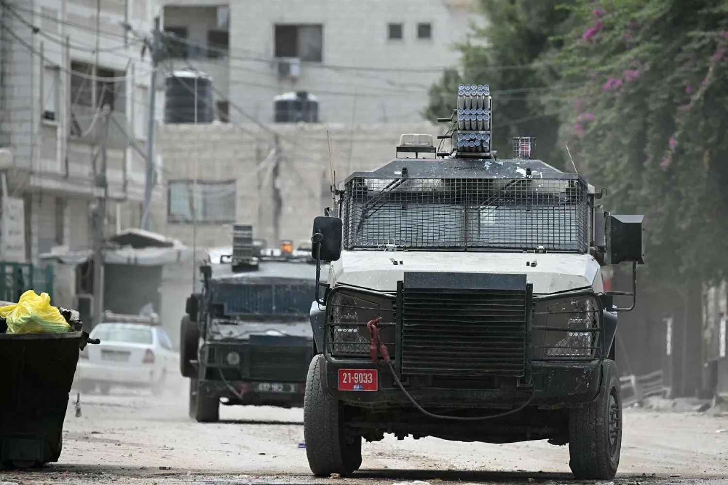 Israeli military vehicles drive down a road during a raid in Jenin in the occupied West Bank on August 28, 2024. (AFP) 