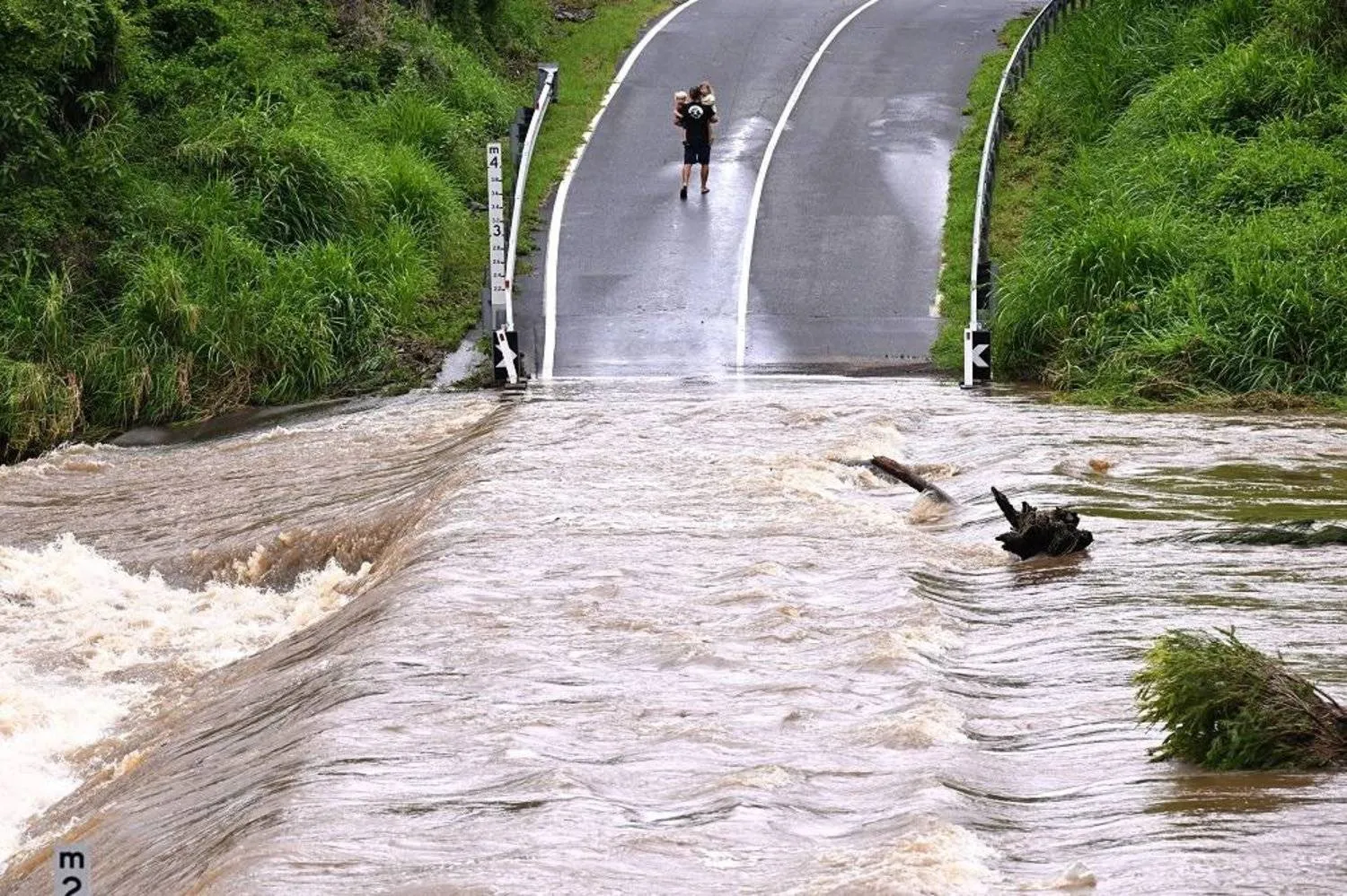 The Coomera river is seen cutting a road at Clagiraba Road on the Gold Coast Tuesday, January 2, 2024. (AAP)
