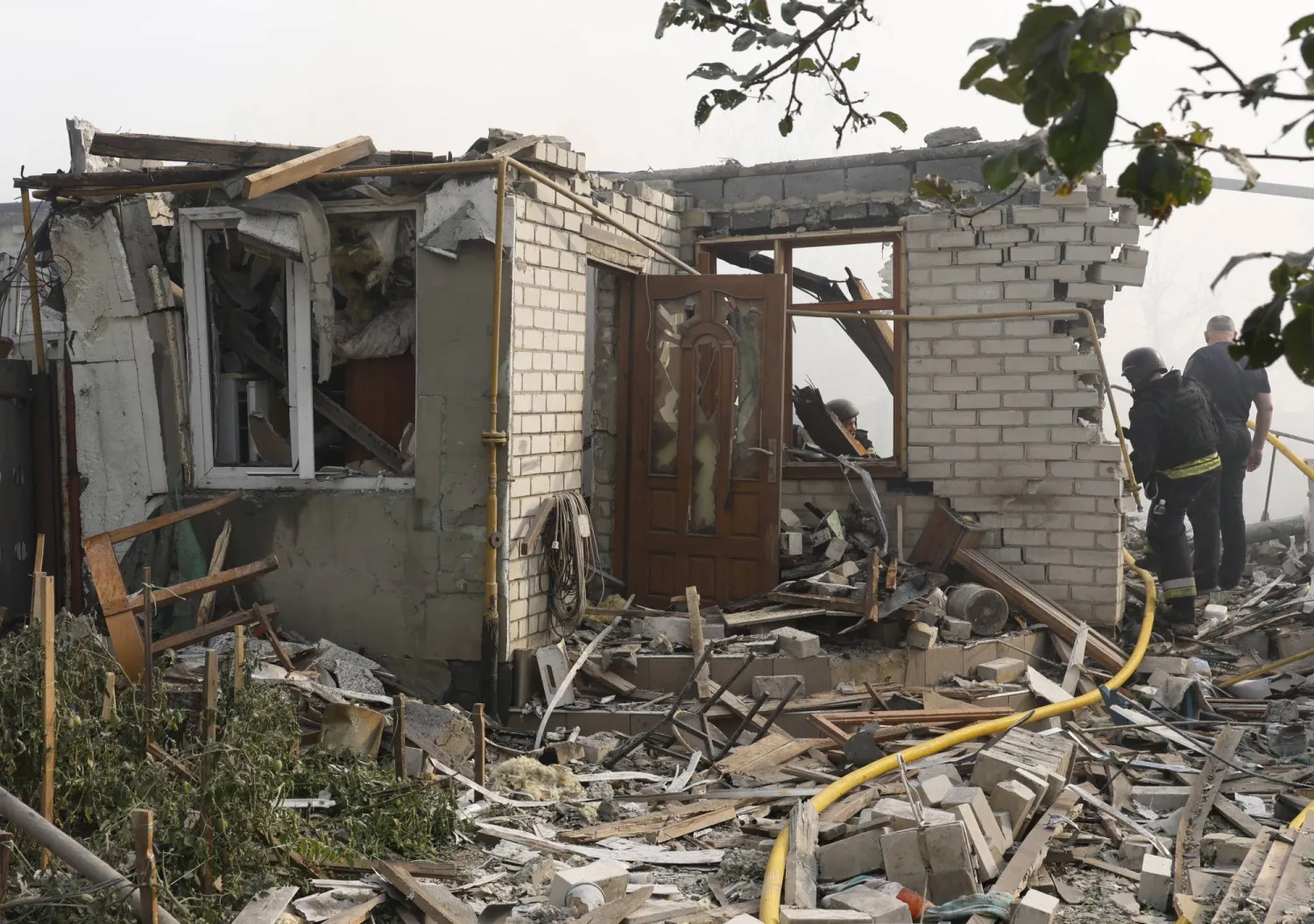 Ukrainian rescuers work at the site of a missile strike on a private building in Cherkaska Lozova, Kharkiv region, northeastern Ukraine, 31 August 2024, amid the Russian invasion. EPA/SERGEY KOZLOV