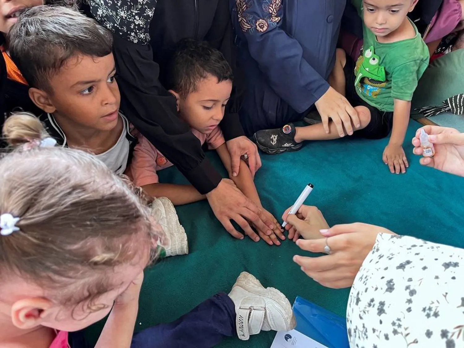  Palestinians gather during a polio vaccination campaign, amid the Israel-Hamas conflict, in Deir al-Balah in the central Gaza Strip, September 1, 2024. (Reuters)