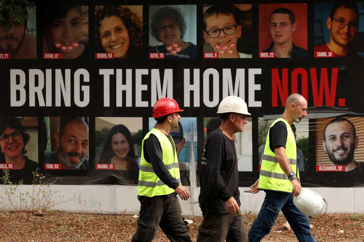People walk next to the poster depicting Alexander Lobanov, whose body was retrieved from Gaza, displayed together with the posters of other hostages kidnapped during the deadly October 7 attack by Hamas, in Tel Aviv, Israel, September 1, 2024. REUTERS/Florion Goga