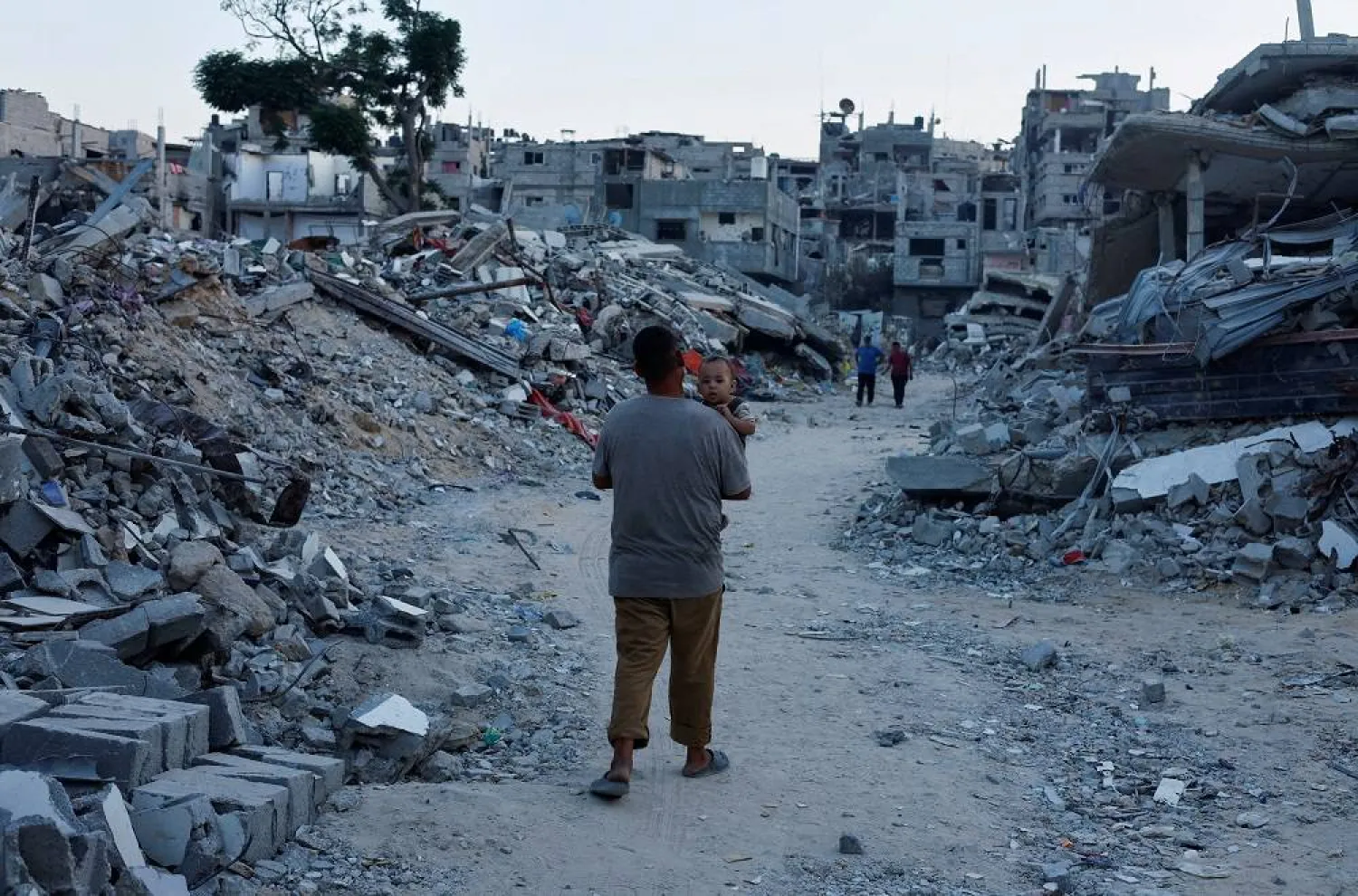A Palestinian walks amidst the rubble of buildings destroyed after an Israeli strike, amid the ongoing conflict between Israel and Hamas, in Khan Younis, in the southern Gaza Strip September 1, 2024. (Reuters)