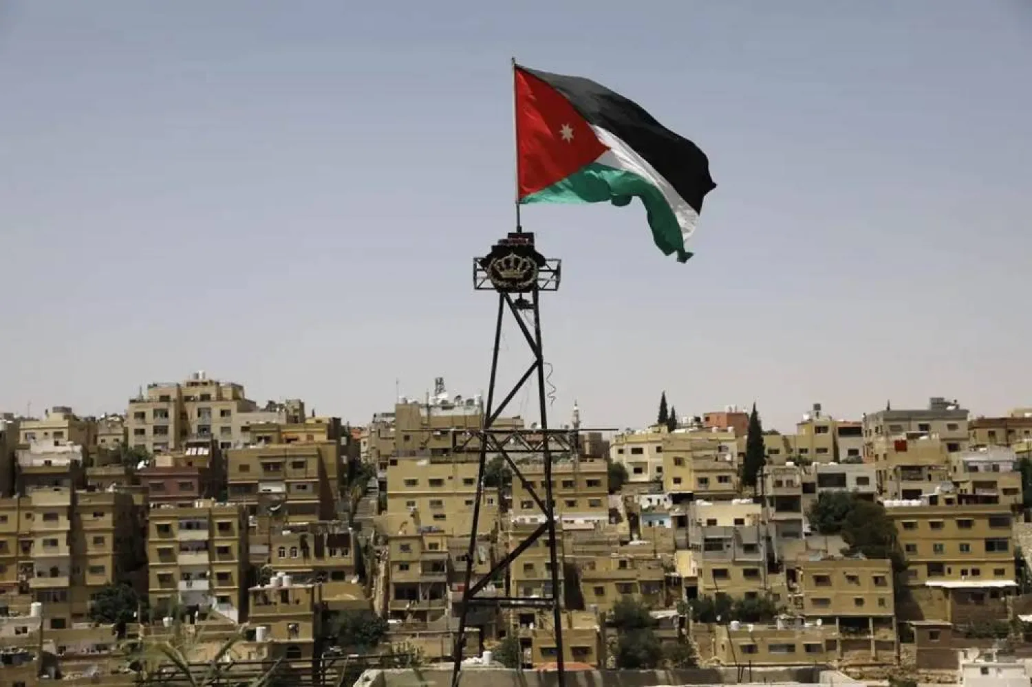 A general view taken from the Jabal al-Qala district shows a Jordanian flag fluttering above the Jordanian capital Amman. (AFP via Getty Images)
