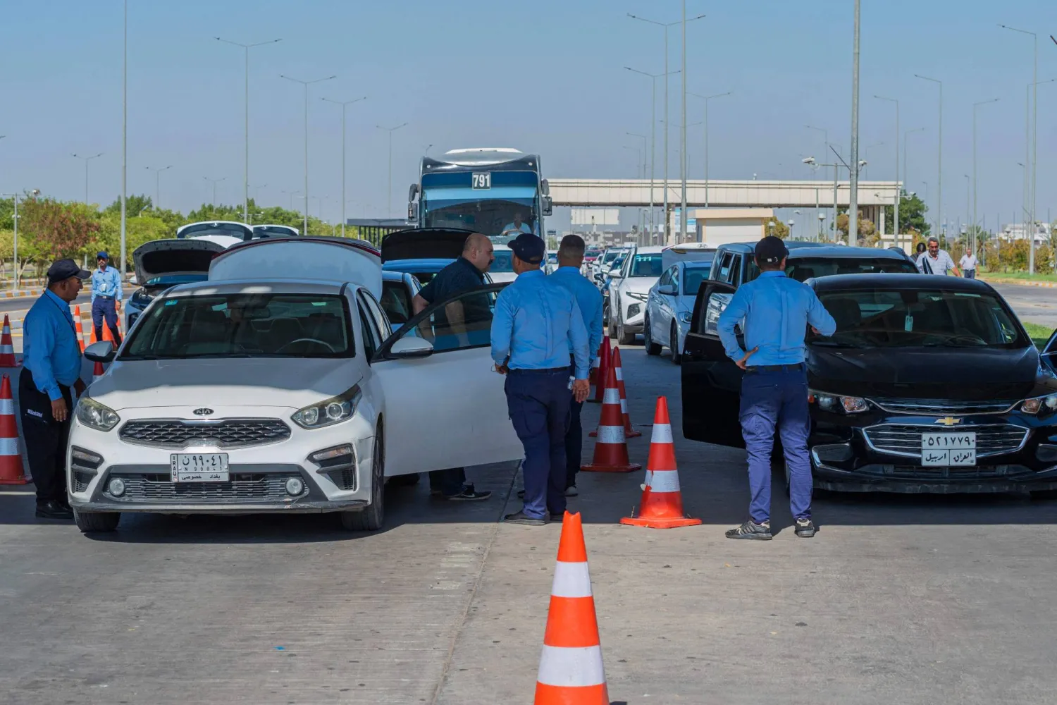 Security agents search private cars arriving at the Baghdad International Airport on August 17, 2024. (Photo by Murtadha RIDHA / AFP)