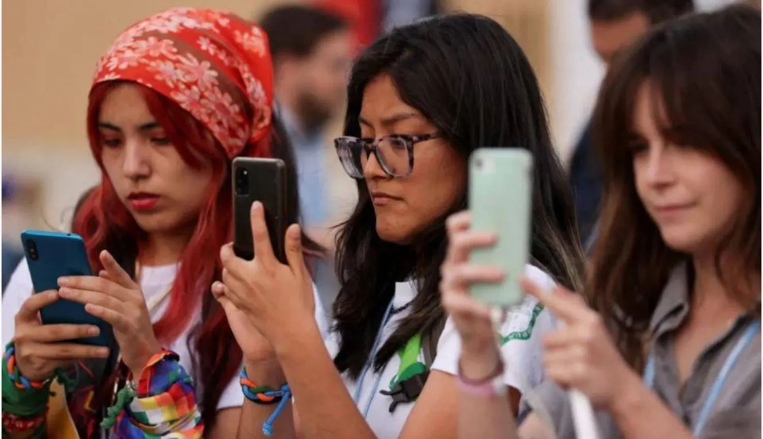 İklim aktivistleri COP27 zirvesi sırasında bir protestoya katılırken kızlar telefonlarını kullanıyor Şarm El-Şeyh, Mısır, 17 Kasım 2022 (Arşiv- Reuters)