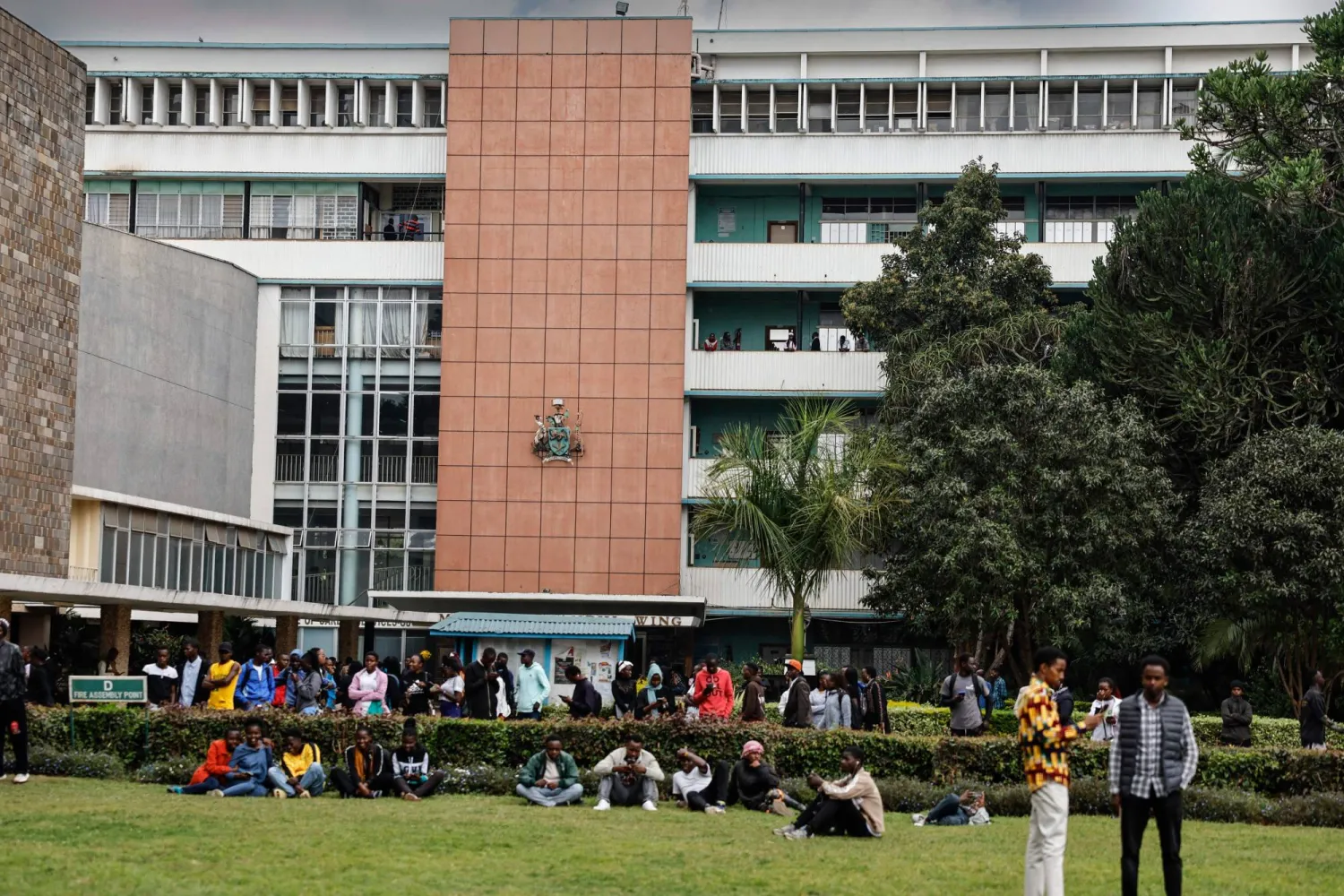 Students gather near a lecture hall at the University of Nairobi main campus in Nairobi on September 2, 2024. (Photo by SIMON MAINA / AFP)
