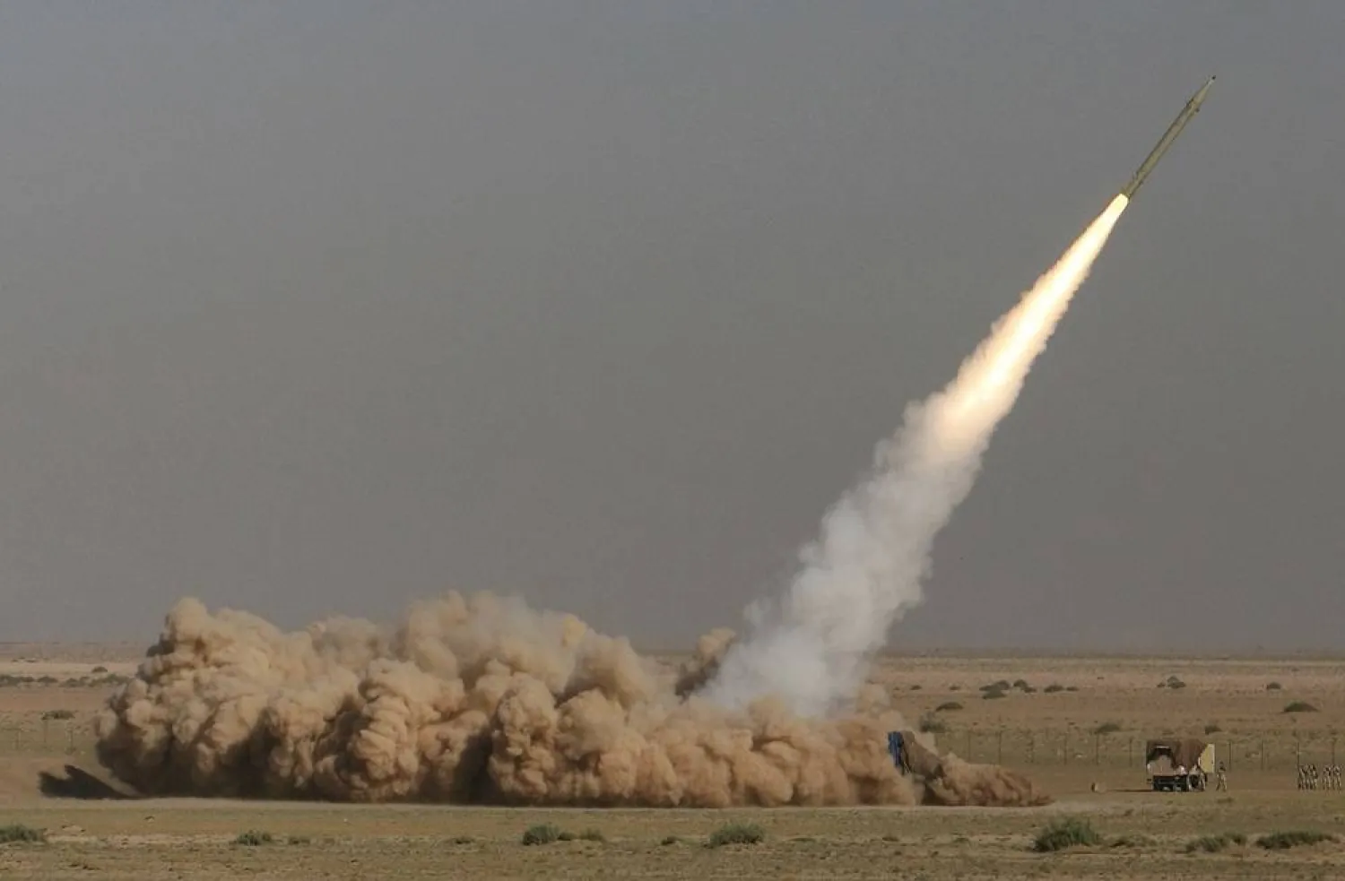 In this photo released by the Iranian semi-official Fars News Agency, Revolutionary Guard's Fateh missile is launched in a drill near the city of Qom, 80 miles (130 kilometers) south of the capital Tehran, Iran, Sept. 27, 2009. (Ali Shaigan/Fars News Agency via AP File)