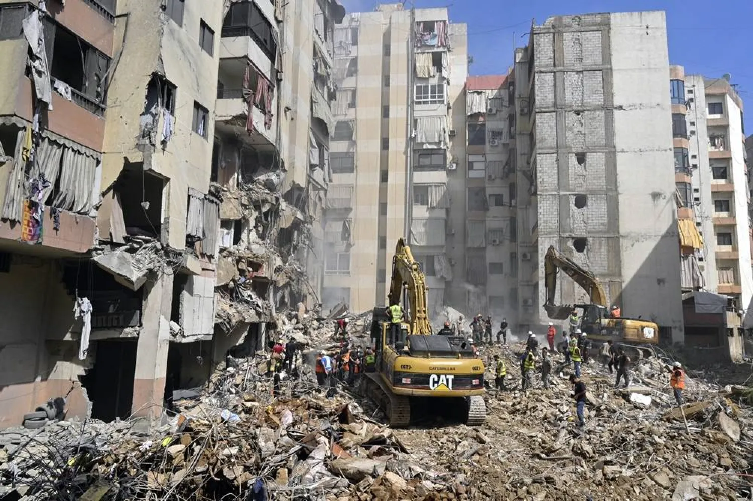 Emergency workers use excavators to clear the rubble at the site which was targeted by an Israeli strike the previous day, in the southern suburb of Beirut, Lebanon, 21 September 2024. (EPA)