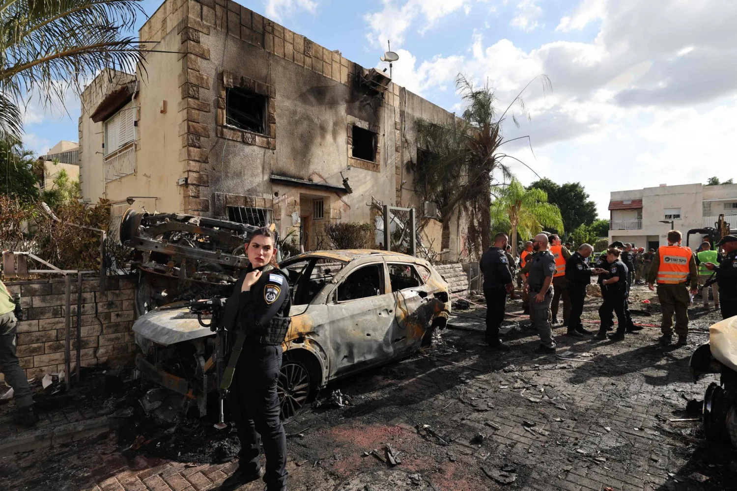 First responders and Israeli security forces gather amid debris and charred vehicles in Kiryat Bialik in the Haifa district of Israel, following a reported strike by Lebanon's Hezbollah on September 22, 2024. (Photo by Jack GUEZ / AFP)