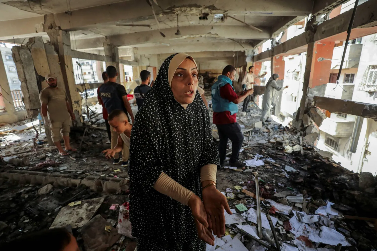 A Palestinian woman reacts as she inspects the damage to a school sheltering displaced people after it was hit by an Israeli strike, amid the Israel-Hamas conflict, at Beach refugee camp in Gaza City, September 22, 2024. REUTERS/Dawoud Abu Alkas