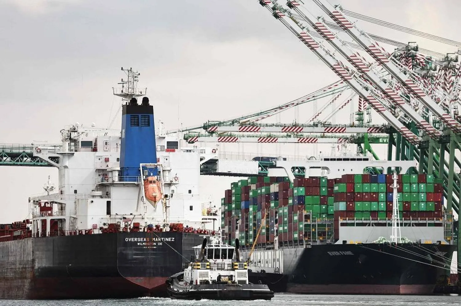 A chemical/oil tanker (L) passes a container ship at the Port of Los Angeles on September 20, 2024 in Los Angeles, California. (Getty Images North America / AFP)