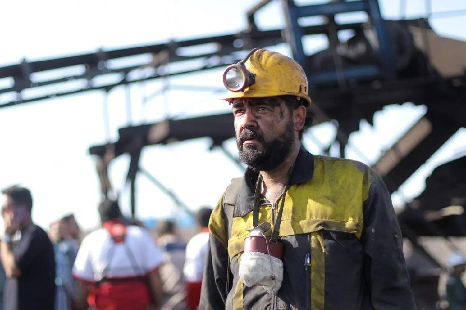An Iranian coal miner waits outside the Tabas coal mine in Tabas, Khorasan province in southeastern Iran, 22 September 2024. (EPA)