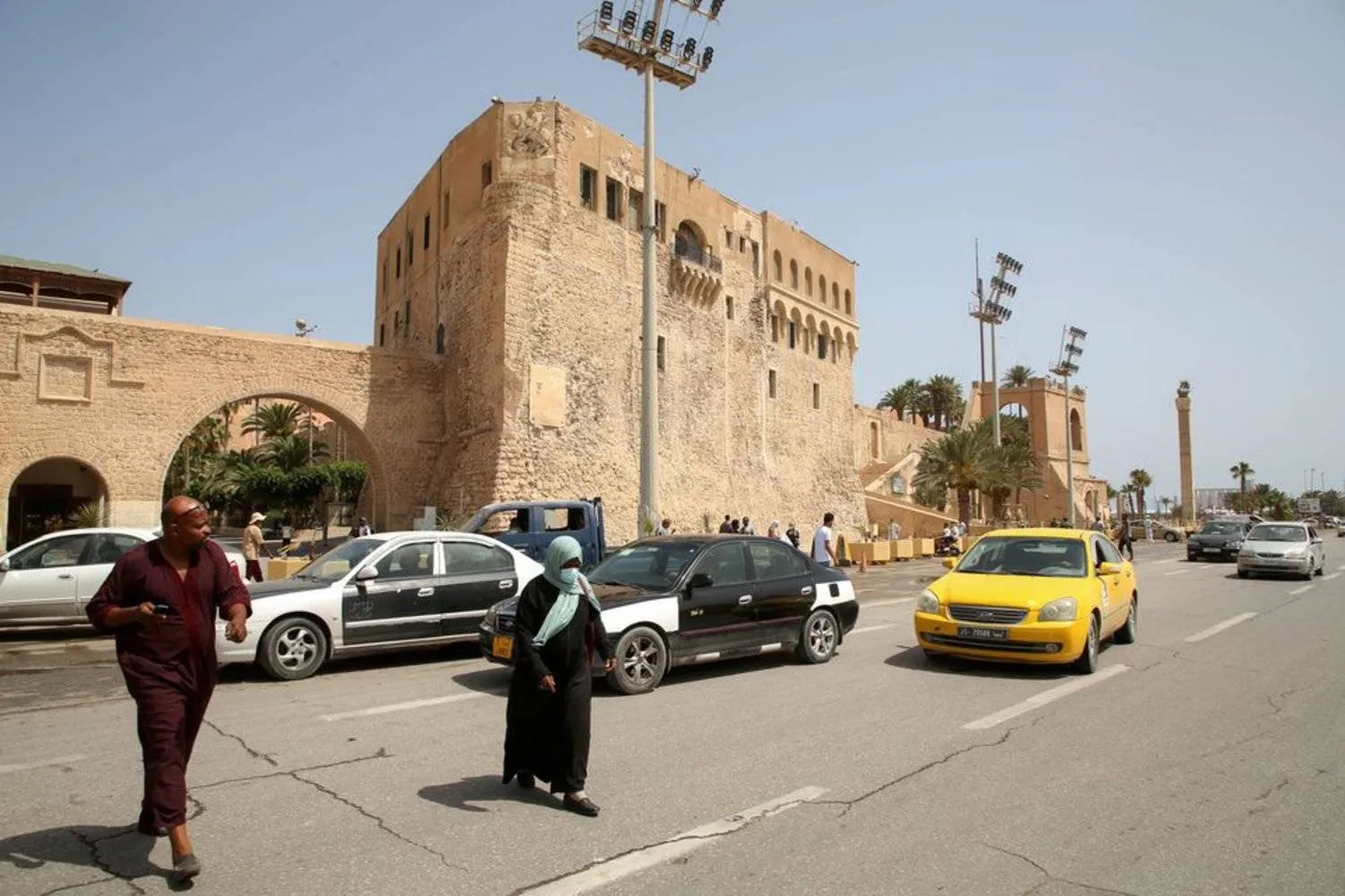 People cross a street at Martyrs Square in Tripoli, Libya, July 5, 2021. (Reuters)
