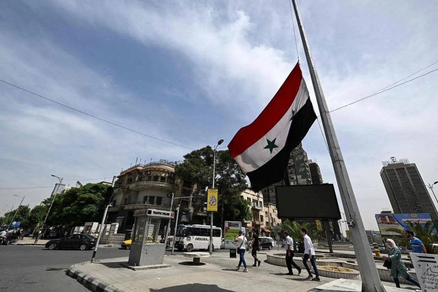 The Syrian flag is flown at half-mast in Damascus on May 20, 2024, after the country announced three days of national mourning following the death of Iran's President alongside his Foreign Minister and others in a helicopter crash near the Azerbaijan border. (AFP)
