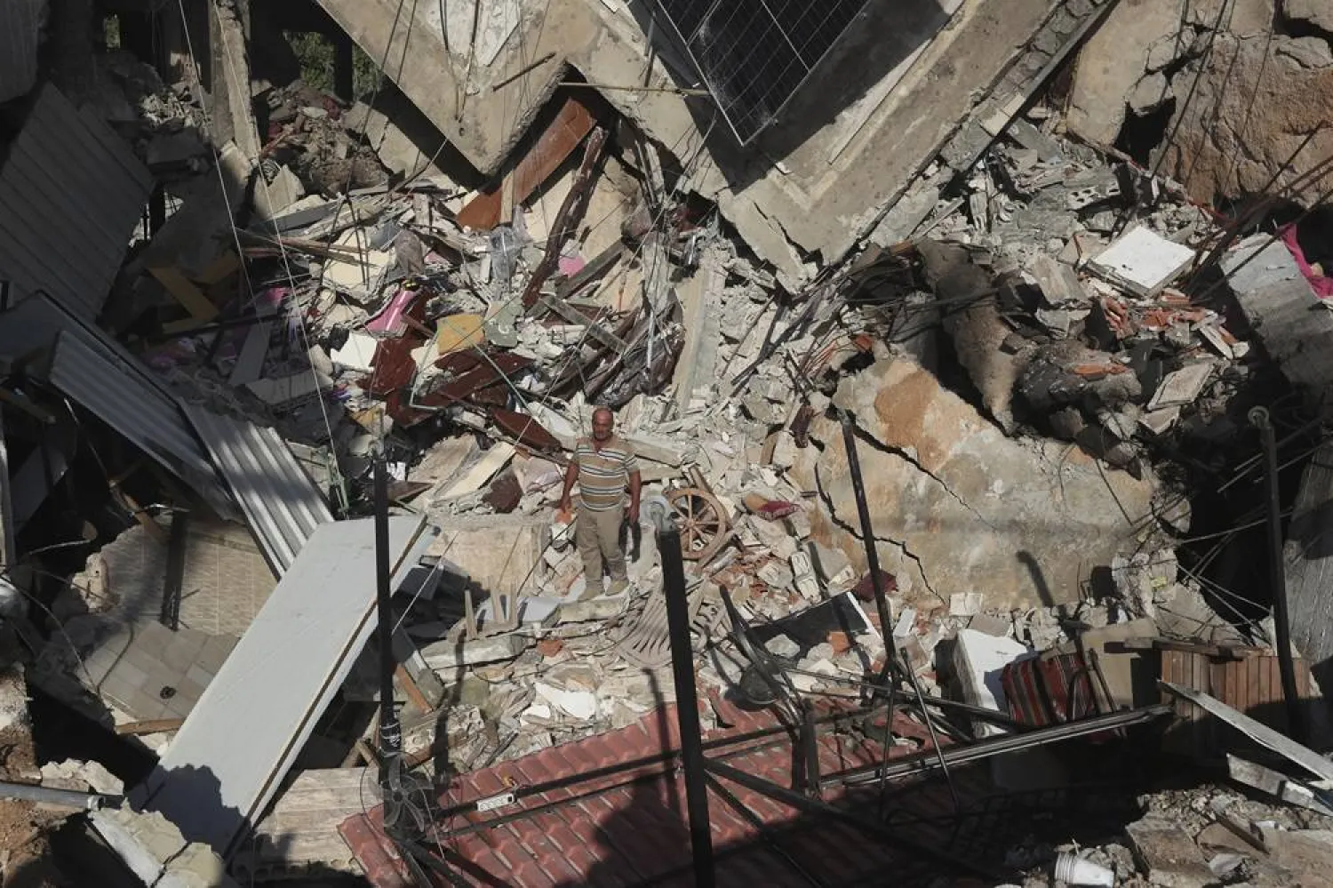 A man stands on the rubble of a building hit in an Israeli airstrike in the southern village of Akbieh, Lebanon, Tuesday, Sept. 24, 2024. (AP)