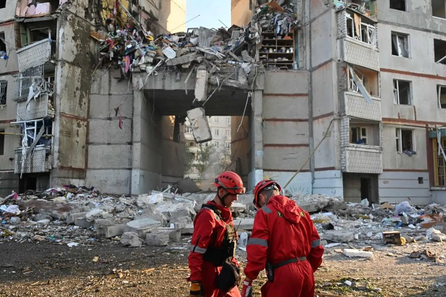  State Emergency Service of Ukraine rescuers stand next to an apartment building destroyed during an airstrike in Kharkiv, on September 24, 2024, amid the Russian invasion of Ukraine. (AFP) 