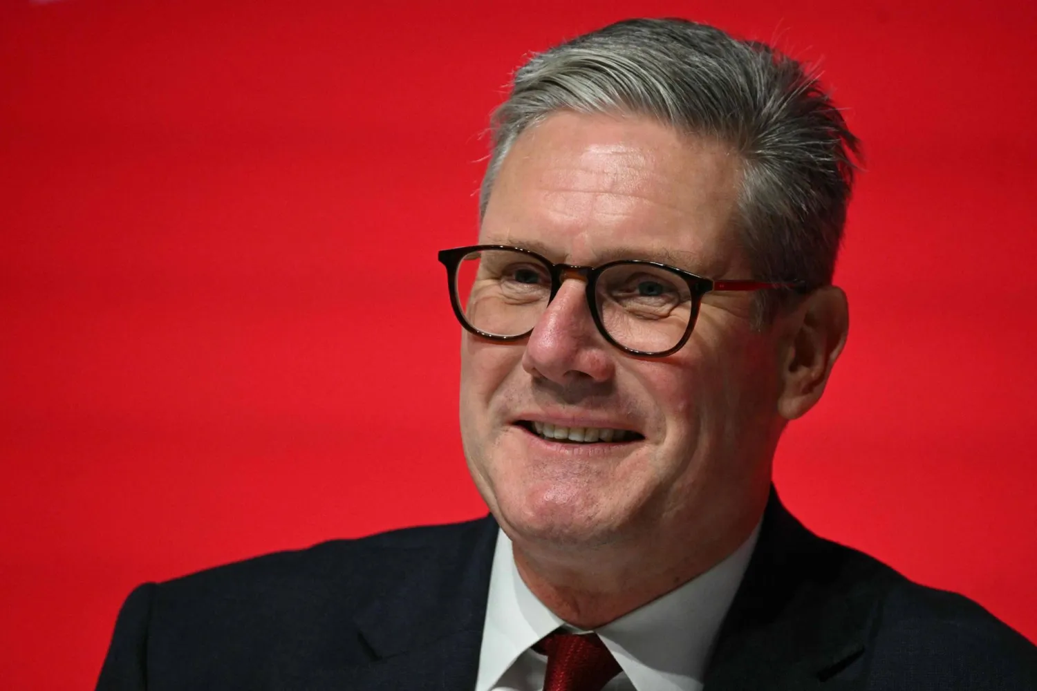 Britain's Prime Minister Keir Starmer smiles on stage on the second day of the annual Labor Party conference in Liverpool, north-west England, on September 23, 2024. (Photo by Oli SCARFF / AFP)