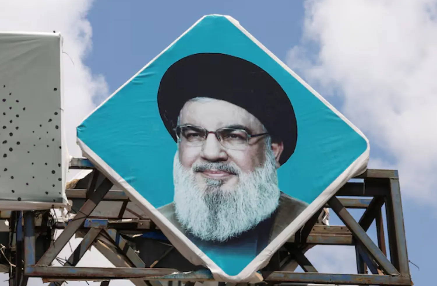 A sign depicting Lebanon's Hezbollah leader Sayyed Hassan Nasrallah is placed in the southern port city of Tyre, Lebanon July 30, 2024. REUTERS/Aziz Taher/File Photo 