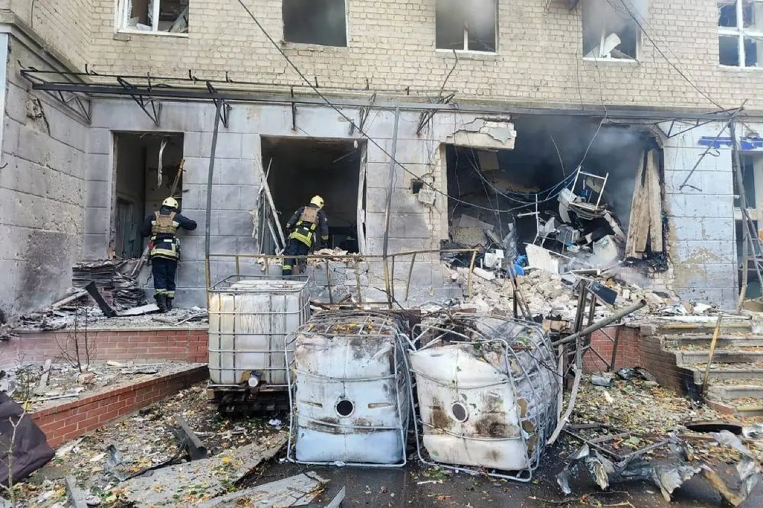 This handout photograph taken and released by the Ukrainian Emergency Service on September 28, 2024, shows rescuers inspecting a damaged hospital building following a drone attack in Sumy. (Photo by Handout / Ukrainian Emergency Service / AFP)  