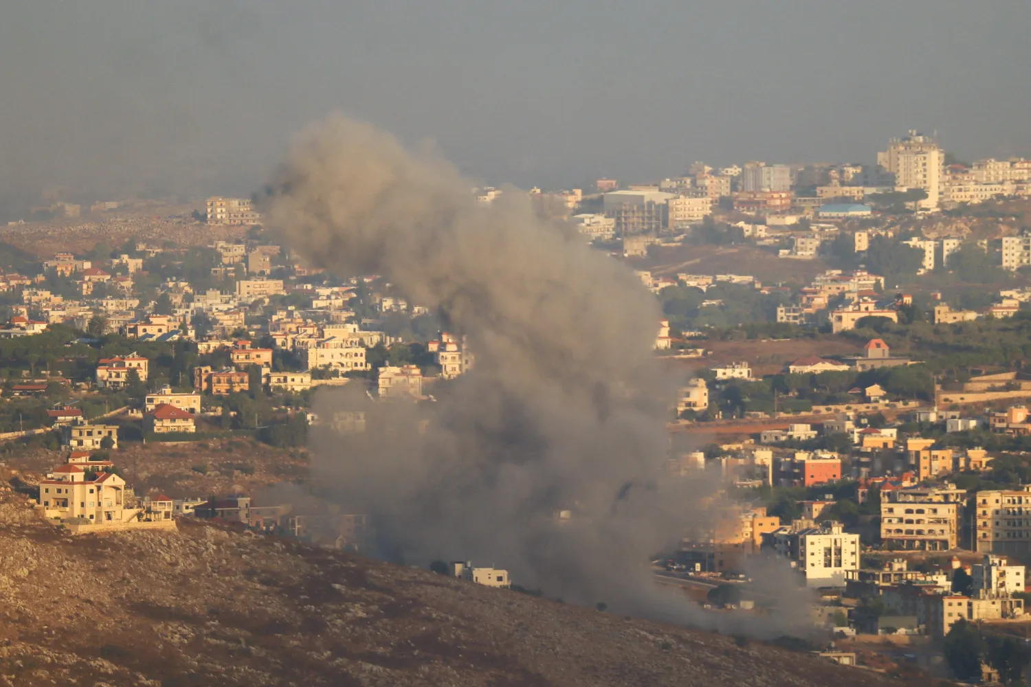 Smoke billows from the site of an Israeli airstrike on the outskirts of the southern village of Habbouch on September 23, 2024. (Photo by Rabih DAHER / AFP)