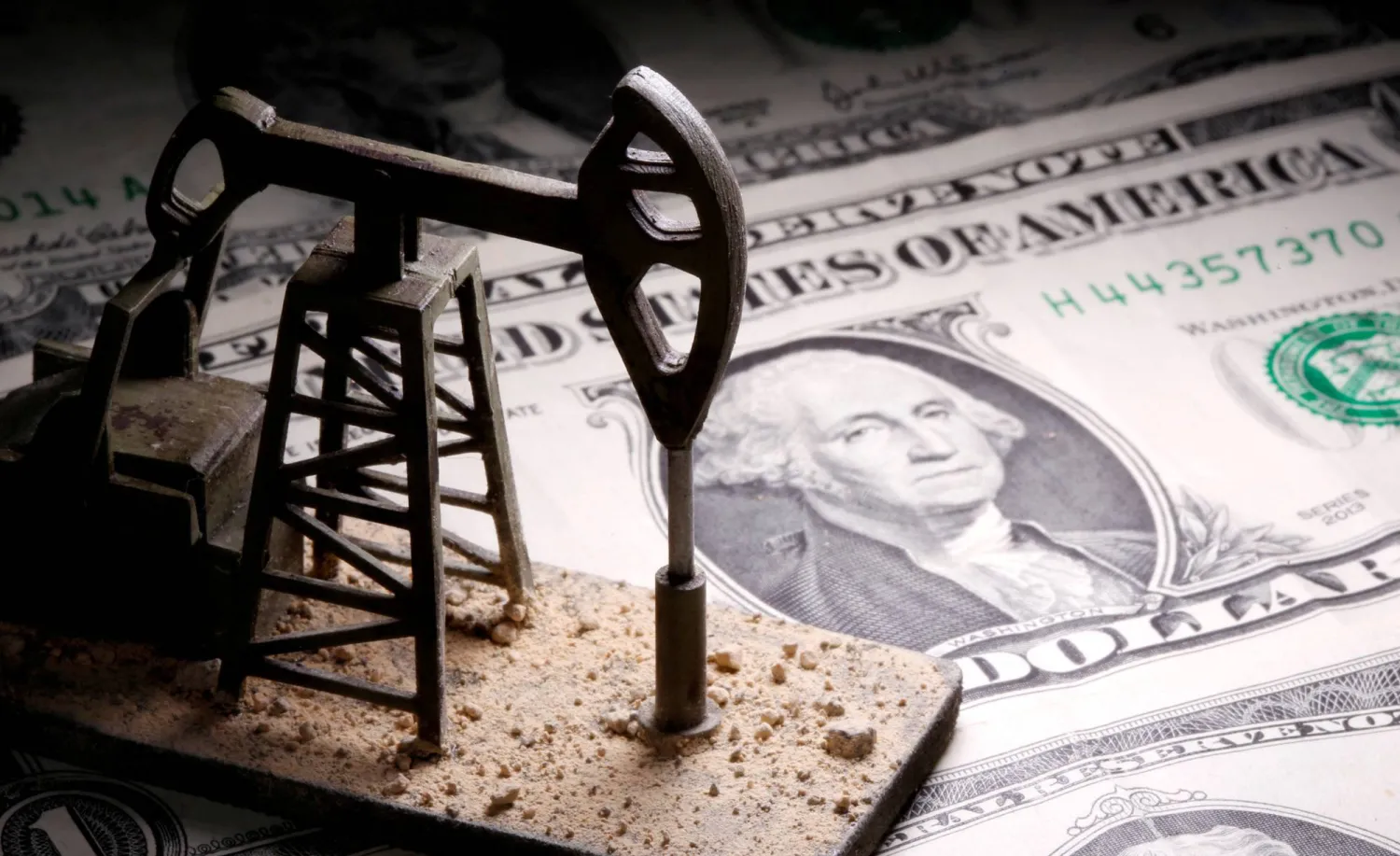 FILE PHOTO: A 3D-printed oil pump jack is placed on dollar banknotes in this illustration picture, April 14, 2020. REUTERS/Dado Ruvic/Illustration/File Photo