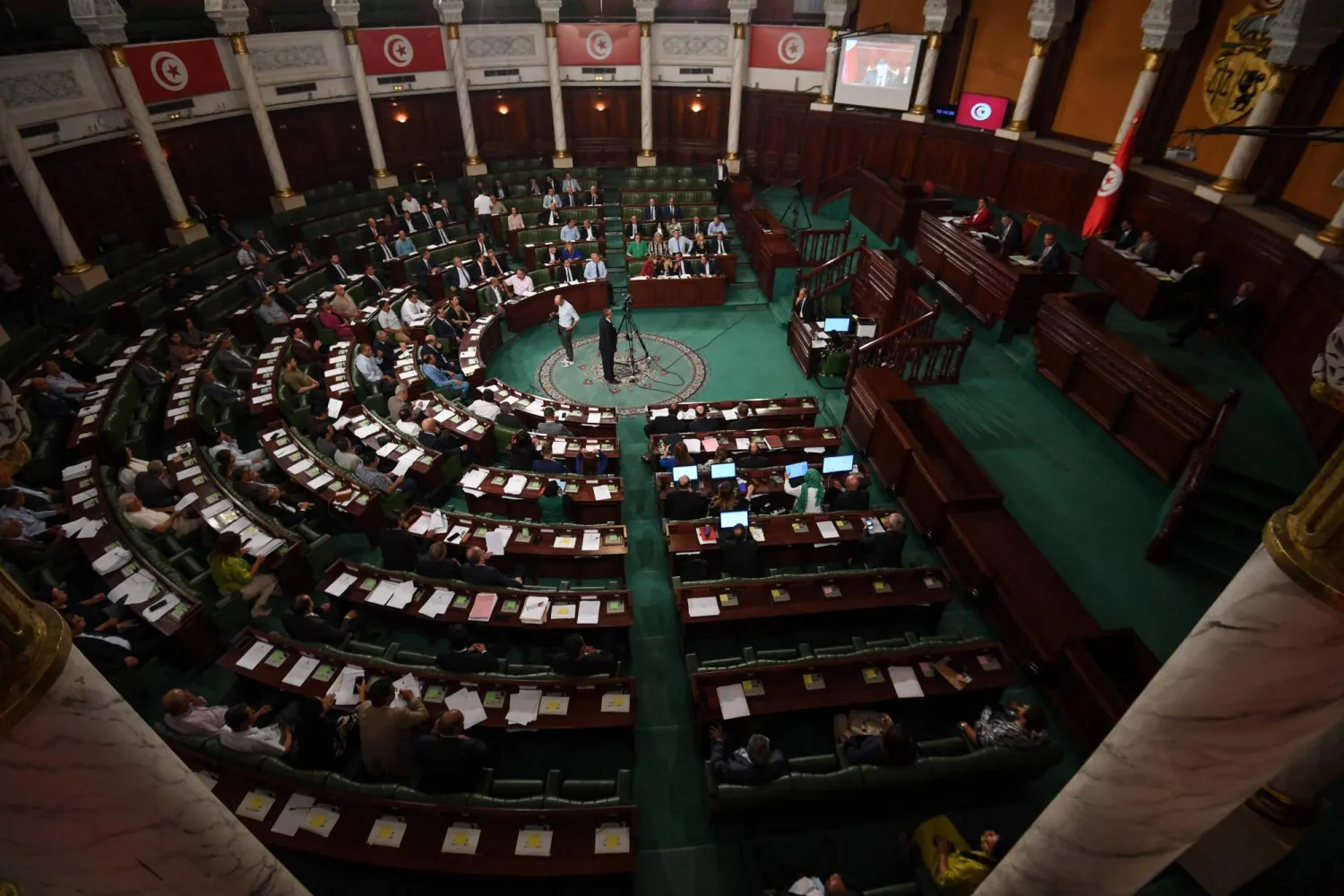 Tunisian members of parliament attend a plenary session to discuss a draft electoral reform, on September 27, 2024 in Tunis. (Photo by FETHI BELAID / AFP)