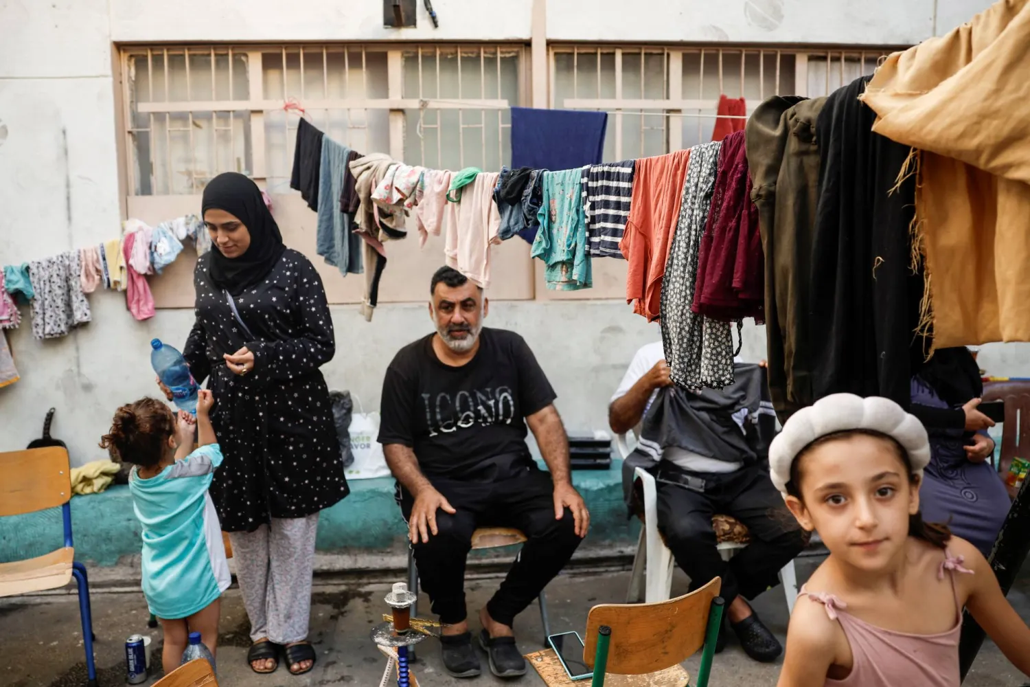 عائلة تجلس في مدرسة تحولت إلى مأوى مؤقت للنازحين في بيروت (رويترز) 