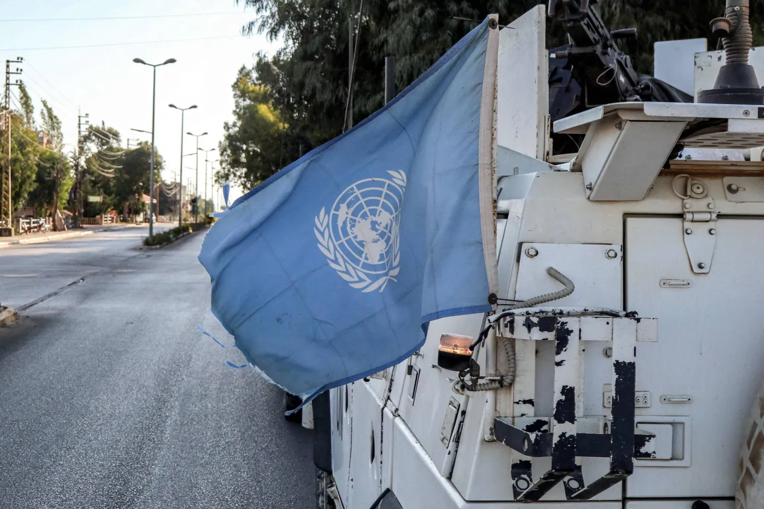 A United Nations flag flies in the back of one of the armored vehicles of the UN Interim Force in Lebanon (UNIFIL) during a patrol around Marjayoun in south Lebanon on October 8, 2024. (Photo by AFP)