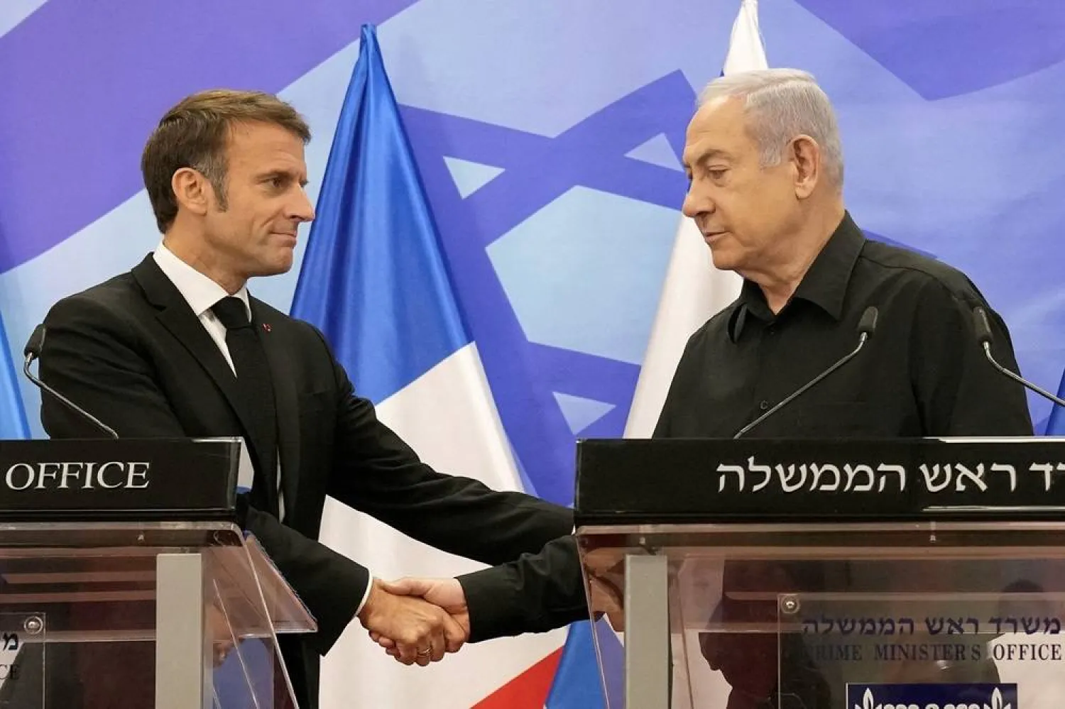 Caption: Prime Minister Benjamin Netanyahu (R) shakes hands with French President Emmanuel Macron (L), as they hold a joint press conference in Jerusalem on October 24, 2023. (AFP) 