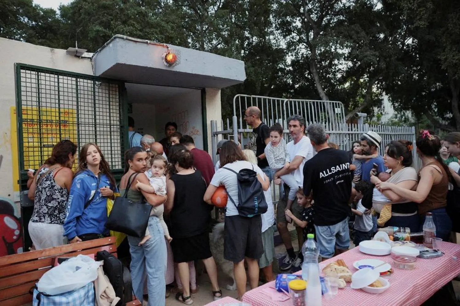  People take shelter as sirens sound in central Israel in response to what the Israel's military says projectiles fired from Lebanon, in Tel Aviv, Israel October 14, 2024. (Reuters)