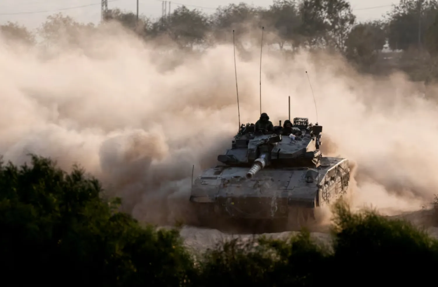 An Israeli tank manoeuvres near the Israel-Gaza border, amid the ongoing conflict between Israel and Hamas, as seen from Israel, October 15, 2024. REUTERS/Amir Cohen 