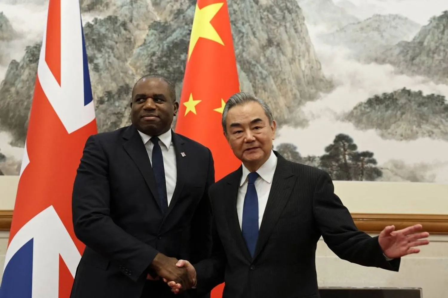  Britain's Foreign Secretary David Lammy (L) and Chinese Foreign Minister Wang Yi shake hands before their meeting at the Diaoyutai State Guesthouse in Beijing on October 18, 2024. (AFP) 